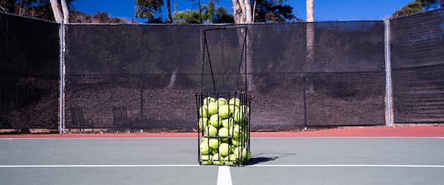 Tennis ball basket full with balls
