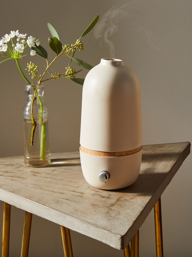 essential oil diffuser with a beautiful white flower