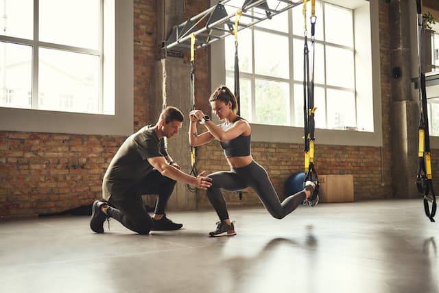 gym exercise with fitness instructor