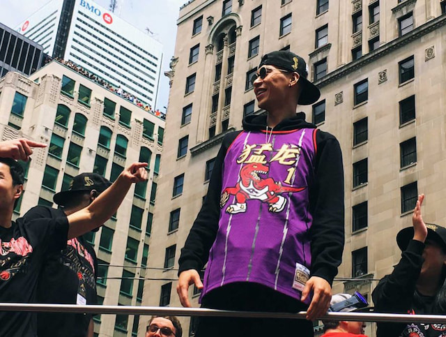 man wearing toronto raptors jersey