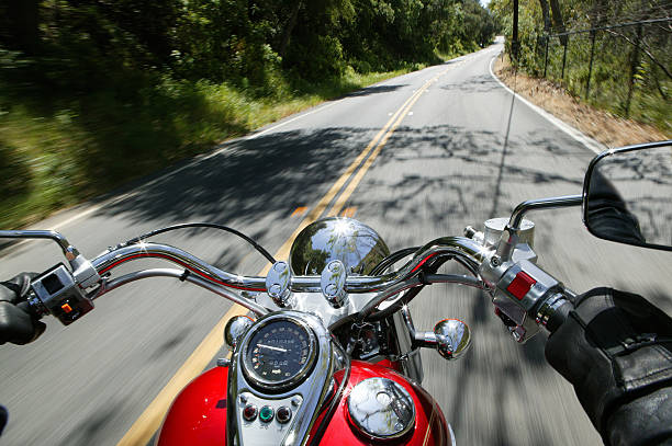 Cruiser motorcycle on a open road from rider point of view.