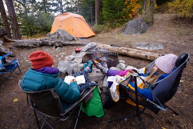 a couple enjoying on foldable camping chairs