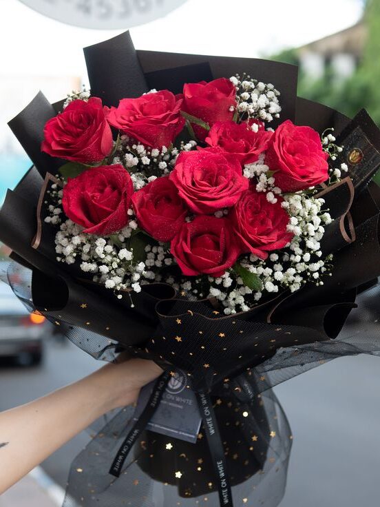 a woman holds Bouquet of Roses