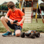 kid playing with rc car