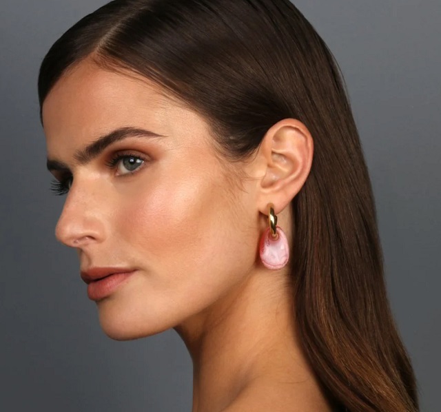 woman wearing pink resin earrings