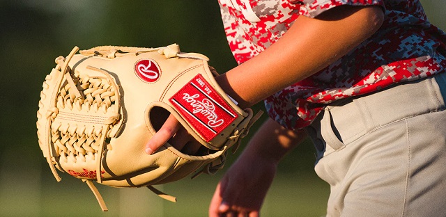 a softball player wearing a softball mitt