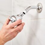 man putting on a new shower head