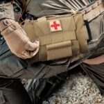a molle medical pouch attached to a soldiers belt