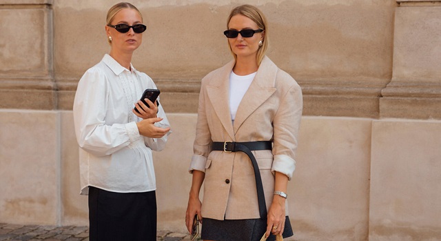 two women dressed in trendy outfits with accessories